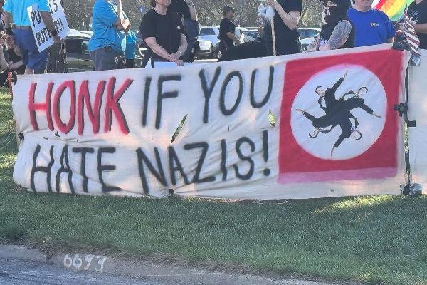 Banner: Honk if you hate Nazis! in Warren, Michigan, May 1, 2025.