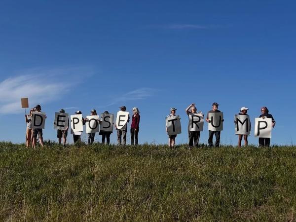 May Day in Kalispel, Montana. People held up letters that spell "Depose Trump."