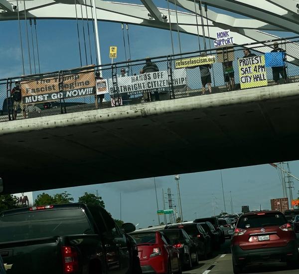 Houston, Texas, Refuse Fascism drop two banners over freeway, May 15, 2025.