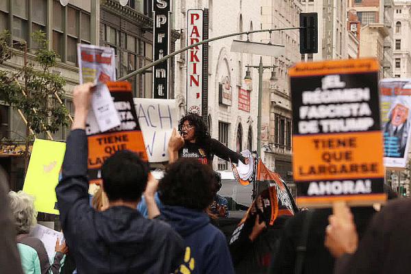 At the Los Angeles Trump Must Go Now rally, speaker at the mic.