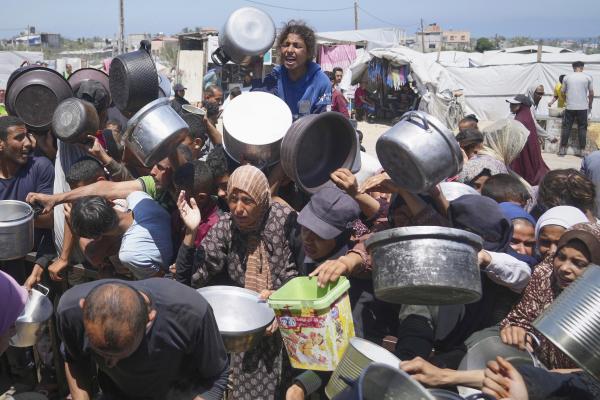 Starving Palestinians struggle to receive food in Khan Younis, in the Gaza Strip, May 23, 2025.