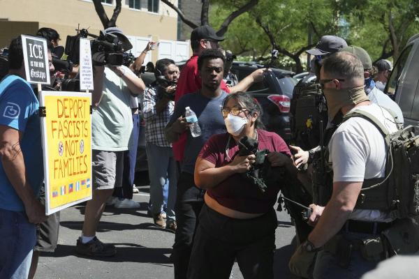 Federal police and ICE agents clash with protesters after an immigration court hearing in Phoenix, Arizona, May 21, 2025.