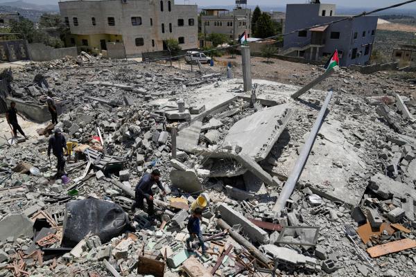 West Bank residents search the rubble of the family house demolished by the Israeli army, May 22, 2025.