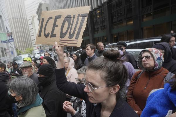 Demonstrator holds up sign saying ICE OUT, protesting ICE arrests in San Francisco, May 28, 2025.