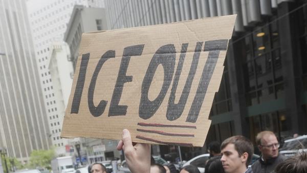 Demonstrator holds up sign saying ICE OUT, protesting ICE arrests in San Francisco, May 28, 2025.
