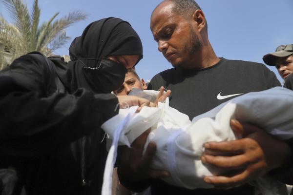Palestinian carries a five-month-old baby who died from malnutrition July 26, 2025.