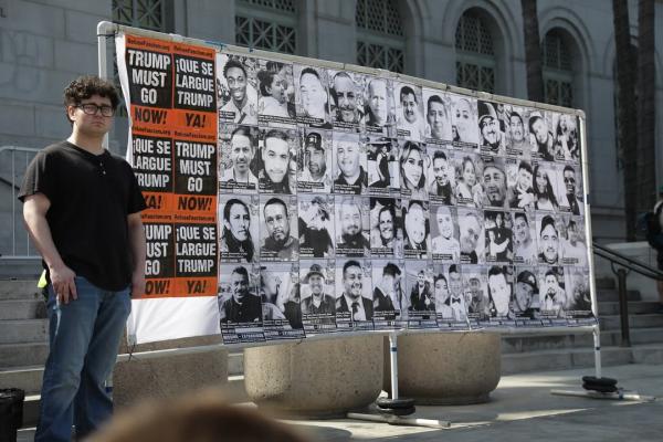 A wall with posters of people kidnapped by ICE, at LA July Fourth protest.