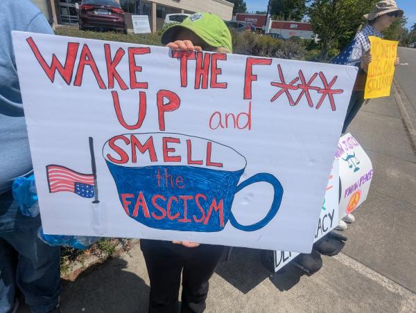 During Seattle's Refuse Fascism protest, this sign, Wake the F up and Smell the Fascism.