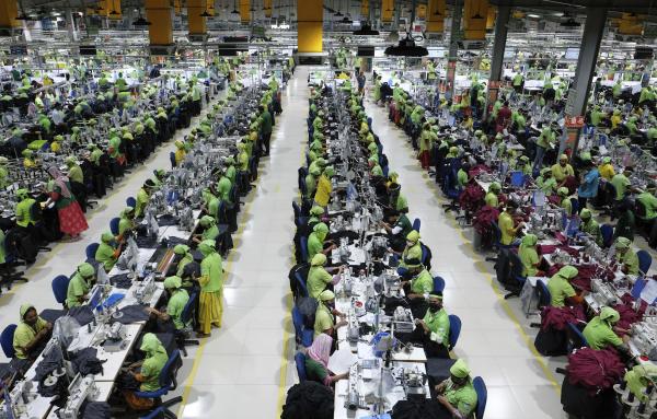 Millions and millions of human beings, including 150 million children, sweat out their lives to produce cheap goods, like at this ready made garment (RMG) factory in Bangladesh, April 2015.