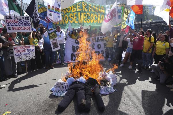 Brazilians burn effigies of Trump and Brazil's former President Jair Bolsonaro to protest a Trump's 50% tariff on Brazilian goods, August 1, 2025.
