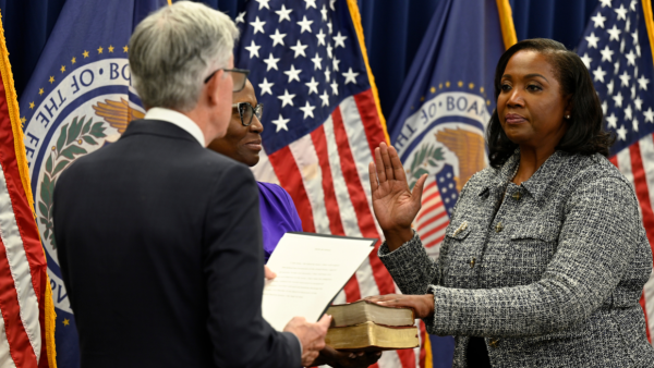 Lisa Cook being sworn in as a member of the Federal Reserve Board of Governors by Jerome Powell, May 2022.