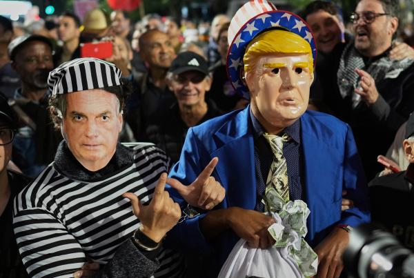 Protesters wear masks of former Brazil president Bolsonaro and Trump, July 10, 2025.