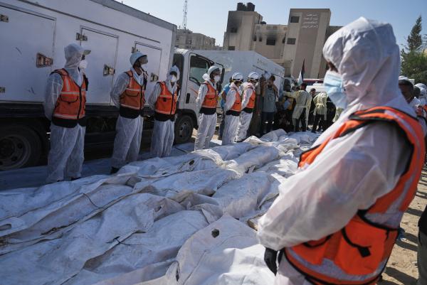 Bodies of Palestinians returned from Israel are prepared for mass burial, October 22, 2025.