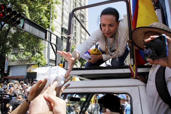 August 17, 2024, at a rally protesting Maduro's win in July, Maria Corina Machado reaches out to grab vote tally sheets.
