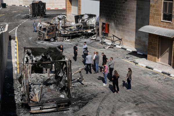 Palestinians survey damage from Israeli settlers attack on an industrial zone in West Bank village near Tulkarm, November 12, 2025.