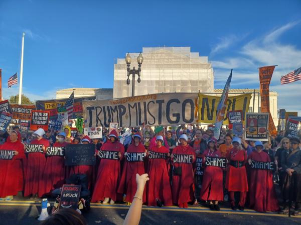 Handmaids with Trump Must Go Now banner in front of Supreme Court, November 5, 2025.