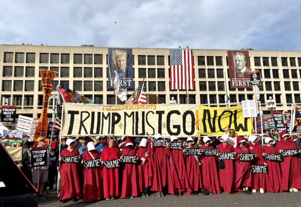 Army of Handmaids pause in front of Labor Department during Trump Must Go Now protest, November 5, 2025.