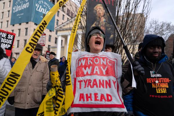 Demonstrators protest during a march near the White House, December 13, 2025.
