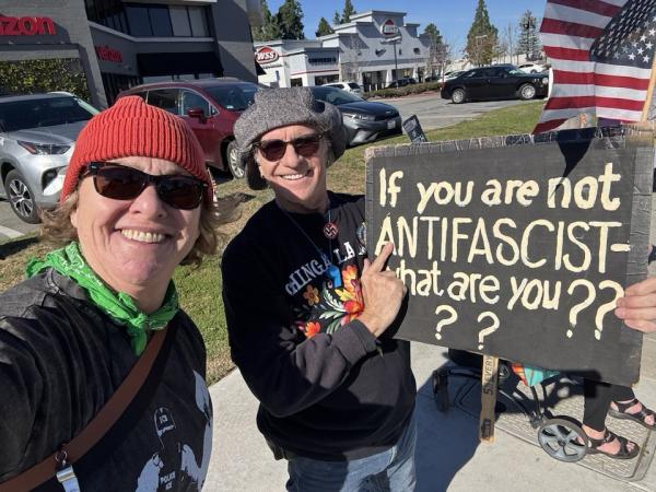 2 people in Santa Ana, California, with sign: If you aren't anti-fascist, what are you????