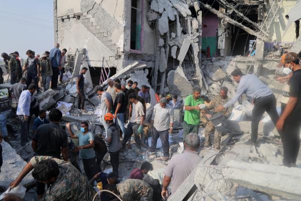  Searching through the rubble from an Israeli-U.S. strike on a girls' elementary school in Minab, Iran, February 28, 2026.