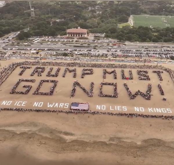 Thousands of protesters gathered at Ocean Beach in San Francisco on No Kings Day, March 28, 2026, to spell out TRUMP MUST GO NOW!