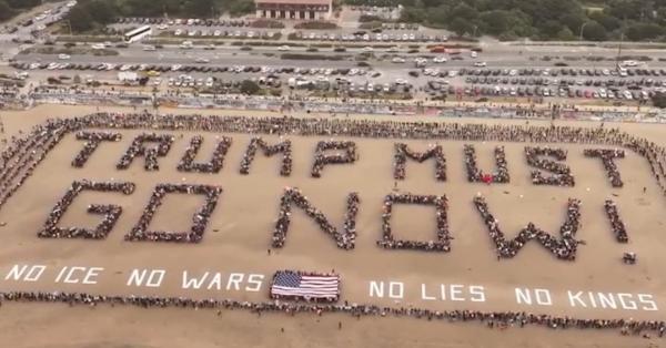 Thousands of protesters gathered at Ocean Beach in San Francisco on No Kings Day, March 28, 2026, to spell out TRUMP MUST GO NOW!