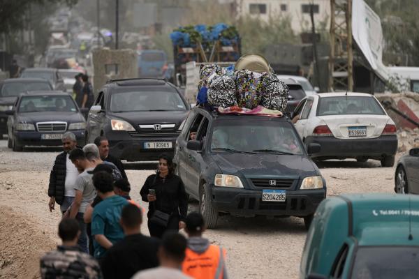 April 17, 2026, people returning to their village in southern Lebanon must cross a bridge destroyed by an Israeli airstrike.