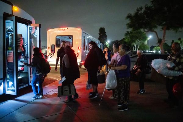 Evacuees from chemical plant leak board bus to go to shelter, May 22, 2026.