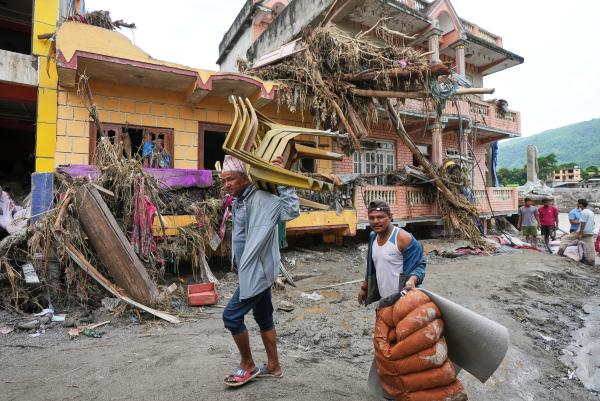 Nepal residents salvage what they can from their damaged homes filled with mud and debris in Devigat district, August 29, 2026.