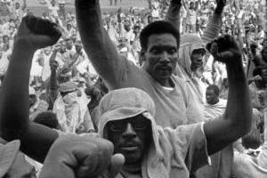 Attica prisoners with fists in the air.