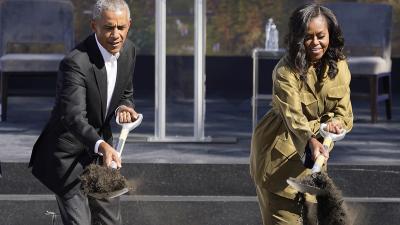 Barack and Michelle Obama shovel dirt for their library in Chicago.