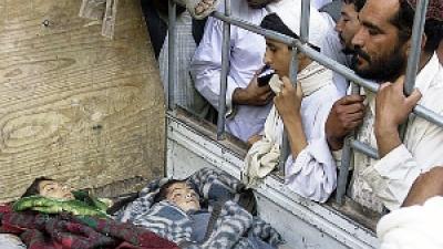 Relatives look at children killed by a 2009 U.S. airstrike in Kandahar Afghanistan