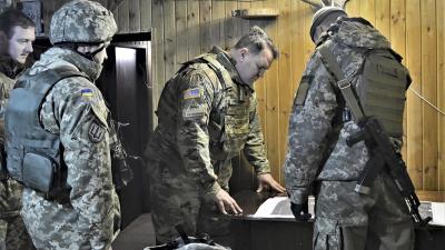 U.S. embassy delegation led by Army military attaché reviews map with Ukrainian officers who are conducting military operations against pro-Russian forces in eastern Ukraine.