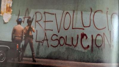 After beating of Rodney King, graffiti on wall in LA: Revolución La Solución.