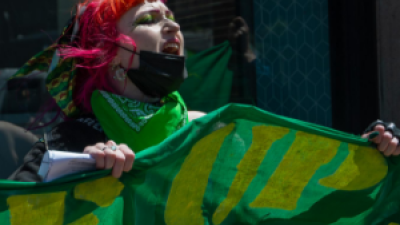 Woman with green banner