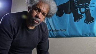 Albert Woodfox with Black Panther Party banner