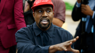 Kanye West wearing a MAGA hat.