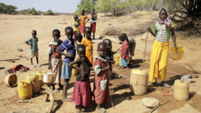 In drought-striken Kenya, children fetch water from ground water well.