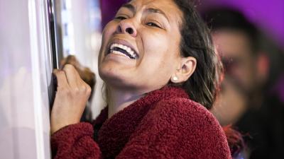 Woman distraught at Mexico detention center fire kills dozens, March 27, 2023.