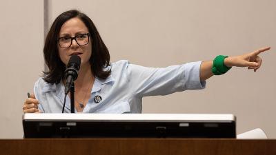 Sunsara Taylor points while speaking, "Woke Lunacy vs Real Revolution" talk at UCLA, May 25, 2023.