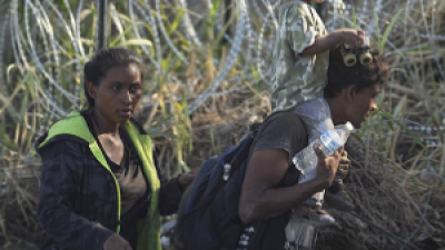 Immigrants in river, barbed wire