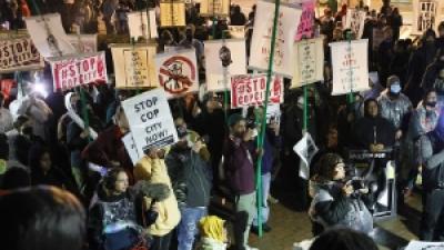 Large, diverse crowd of protesters with "Stop Cop City" signs