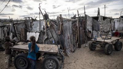 Palestinian woman stands near her house on the outskirts of Khan Younis Refugee Camp in the southern Gaza Strip, November 2020.
