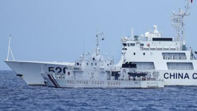 Chinese and Philippines military vessels in a contested area of the South China Sea