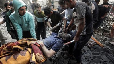 Injured man in Khan Younis refugee camp pulled from rubble, November 18, 2023.