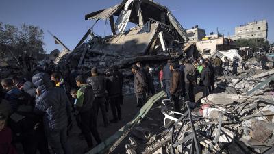 Palestinians search for survivors in the rubble of a residential building destroyed by an Israeli airstrike, in Rafah, December 15, 2023.