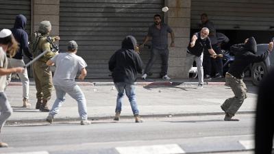 Palestinians and Israeli settlers clash in West Bank, October 13, 2022.