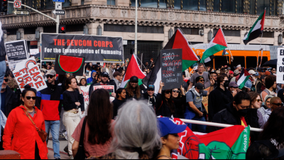 The Revcom Corps banner in the midst of thousands in Los Angeles who came into the streets on a rainy day to protest genocide in Palestine, March 2, 2024.