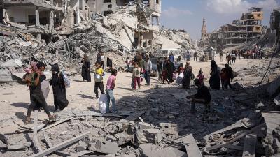 Palestinians search rubble after Israeli air and ground offensive in Khan Younis, April 8, 2024.