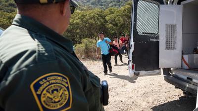 Immigrants seeking asylum are met by Border Patrol as they approach the U.S.-Mexico border, June 5, 2024.